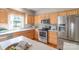 Well-lit kitchen features wood cabinets, stainless steel appliances, and a convenient island at 2619 Merion Hills Ct, Charlotte, NC 28269