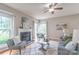 Bright living room featuring a fireplace, hardwood floors, and multiple windows with scenic views at 2619 Merion Hills Ct, Charlotte, NC 28269