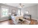 Bright bedroom with a ceiling fan, hardwood floors, a large bed, and lots of natural light at 2619 Merion Hills Ct, Charlotte, NC 28269