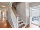 Hallway with a staircase and a glass door to a patio with furniture at 2619 Merion Hills Ct, Charlotte, NC 28269