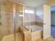 Bright bathroom featuring a walk-in shower and large soaking tub at 3009 Palm Dr, Fort Mill, SC 29715