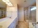 Neutral bathroom featuring a double sink vanity, a shower and a large soaking tub at 3009 Palm Dr, Fort Mill, SC 29715