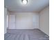 Neutral bedroom featuring carpeted floors and two white doors in the room at 3009 Palm Dr, Fort Mill, SC 29715