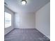 Neutral bedroom featuring carpeted floors and a window with white blinds providing natural light at 3009 Palm Dr, Fort Mill, SC 29715
