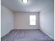 Neutral bedroom featuring carpeted floors and a window with white blinds providing natural light at 3009 Palm Dr, Fort Mill, SC 29715