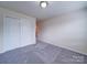 An empty bedroom features neutral walls and plush carpet with a closet and door frame at 3009 Palm Dr, Fort Mill, SC 29715
