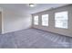 Spacious bedroom featuring plush carpet and abundant natural light from three windows at 3009 Palm Dr, Fort Mill, SC 29715