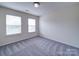 An empty bedroom offers neutral walls and plush carpet with lots of natural light at 3009 Palm Dr, Fort Mill, SC 29715