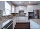 Close-up of the kitchen area featuring granite countertops, stainless steel appliances, and mosaic backsplash at 3009 Palm Dr, Fort Mill, SC 29715