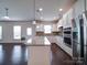 Open kitchen design with stainless appliances, granite countertops, and hardwood flooring at 3009 Palm Dr, Fort Mill, SC 29715