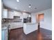 Modern kitchen with granite countertops, stainless steel appliances, and white cabinets at 3009 Palm Dr, Fort Mill, SC 29715