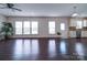 Spacious living room with hardwood floors and natural light flowing through large windows at 3009 Palm Dr, Fort Mill, SC 29715