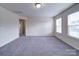 Versatile living room with neutral carpet and natural light from two windows at 3009 Palm Dr, Fort Mill, SC 29715