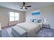Serene main bedroom with a coastal art piece, ceiling fan and two side tables at 3009 Palm Dr, Fort Mill, SC 29715