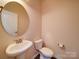 Stylish powder room features a pedestal sink and neutral color scheme at 3009 Palm Dr, Fort Mill, SC 29715