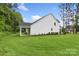 Expansive backyard with lush green lawn, well-maintained landscaping and a covered porch at 3222 Player Ct, Salisbury, NC 28144