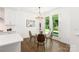Cozy dining area featuring a glass table, elegant chandelier, and access to the outdoor patio at 3222 Player Ct, Salisbury, NC 28144