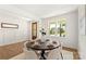 Bright dining area featuring a modern round table set for dinner, hardwood floors, and natural light at 3222 Player Ct, Salisbury, NC 28144