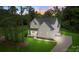 Beautiful two-story home featuring lush green lawn, manicured landscaping, and a long, private driveway at 3222 Player Ct, Salisbury, NC 28144