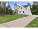 Striking two-story home with a long driveway and luscious green lawn surrounded by mature trees at 3222 Player Ct, Salisbury, NC 28144