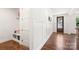Inviting foyer featuring a built-in bench, sleek paneling, and rich hardwood flooring at 3222 Player Ct, Salisbury, NC 28144