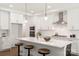 Modern kitchen boasts white cabinetry, stainless steel appliances, a large island, and stylish pendant lighting at 3222 Player Ct, Salisbury, NC 28144