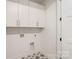 Well-lit laundry room featuring white cabinets, modern appliances hook-ups, and patterned tile at 3222 Player Ct, Salisbury, NC 28144