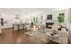 Open-concept living room featuring hardwood floors, a cozy fireplace, and seamless flow to the kitchen and dining area at 3222 Player Ct, Salisbury, NC 28144