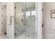 Modern bathroom featuring a glass-enclosed shower with marble tiles and elegant gold fixtures at 3222 Player Ct, Salisbury, NC 28144