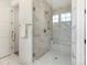 Elegant bathroom with a glass-enclosed shower showcasing marble tiles and gold hardware at 3222 Player Ct, Salisbury, NC 28144