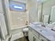 Bathroom featuring a shower-tub combo, white cabinets, a vanity with sink, and a large mirror at 325 Jordan Ave, Salisbury, NC 28159