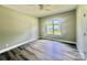This bedroom is a blank canvas with hardwood floors, white trim, and a sun-filled window at 325 Jordan Ave, Salisbury, NC 28159