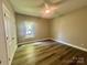 Bright bedroom features wood-look flooring, neutral walls, a ceiling fan, and a window bringing in natural light at 325 Jordan Ave, Salisbury, NC 28159