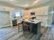 Bright kitchen with white cabinets, subway tile backsplash, stainless steel appliances, and center island with bar seating at 325 Jordan Ave, Salisbury, NC 28159