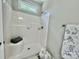 Bright shower features tiled walls, showerhead, a built-in seat, and a window at 325 Jordan Ave, Salisbury, NC 28159