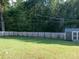 Wide shot of the backyard with a shed, grassy area, and wooden fence at 327 Downing St, Troutman, NC 28166