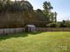 Spacious backyard featuring a storage shed and a well-maintained lawn at 327 Downing St, Troutman, NC 28166