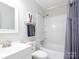 Bathroom features a shower-tub combo and contemporary fixtures, complemented by a sleek mirror and unique wall art at 327 Downing St, Troutman, NC 28166