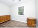 Bright bedroom featuring a large window with natural light and classic wood furniture against a neutral wall at 327 Downing St, Troutman, NC 28166