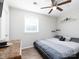 Comfortable bedroom with ceiling fan, decorative shelves, and a gray platform bed, offering a relaxing space at 327 Downing St, Troutman, NC 28166