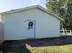 Rear exterior view of the home with a charming white door and a decorative wreath at 327 Downing St, Troutman, NC 28166
