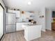 Well-lit kitchen with stainless steel appliances, white cabinets, and granite countertops, perfect for cooking and entertaining at 327 Downing St, Troutman, NC 28166