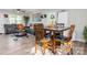 Bright living area featuring a modern rug, dining table, and open floor plan at 327 Downing St, Troutman, NC 28166