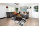 Cozy living room with dual reclining sofas, a modern rug, and a large center table at 327 Downing St, Troutman, NC 28166