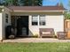 Outdoor patio with wicker furniture, potted plants, and grill near sliding glass door at 327 Downing St, Troutman, NC 28166