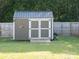 Exterior view of the backyard shed with double doors and a small porch at 327 Downing St, Troutman, NC 28166
