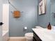 Stylish bathroom with blue walls, light fixtures, and artwork at 3537 Hornets Nest Way # 206, Charlotte, NC 28208