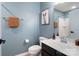 Stylish bathroom with blue walls, light fixtures, and artwork at 3537 Hornets Nest Way # 206, Charlotte, NC 28208