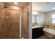 Bright bathroom featuring a glass enclosed shower and relaxing soaking tub at 3537 Hornets Nest Way # 206, Charlotte, NC 28208