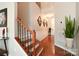 Inviting entryway with hardwood floors and a staircase with wooden and iron railings at 3537 Hornets Nest Way # 206, Charlotte, NC 28208